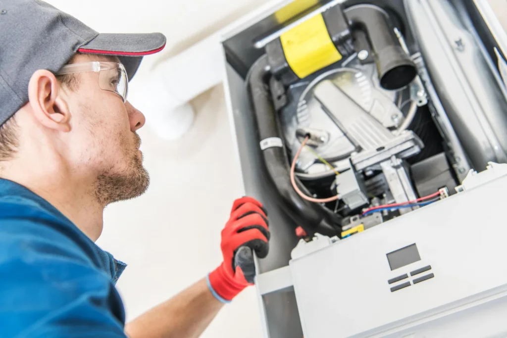 Technician repairing domestic boiler unit