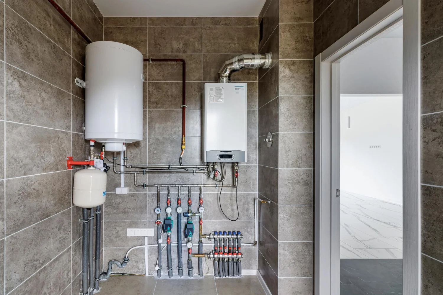 Modern boiler room with water heater and pipes